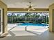 Covered pool with outdoor living area and ceiling fan at 408 Otter Creek Dr, Venice, FL 34292