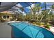 Backyard pool with covered lanai, outdoor furniture, and well-maintained landscaping at 408 Otter Creek Dr, Venice, FL 34292
