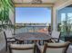 Balcony features an outdoor dining set with views of the community waterway at 501 Tamiami N Trl # 502, Venice, FL 34285