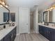 Spacious bathroom with double vanity, stylish mirrors, and a walk-in shower at 501 Tamiami N Trl # 502, Venice, FL 34285