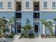 Condo's exterior showcases well-maintained architecture, a welcoming entrance, and tropical landscaping at 501 Tamiami N Trl # 502, Venice, FL 34285