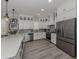 Bright kitchen featuring white cabinets, quartz countertops, stainless steel appliances and luxury vinyl flooring at 501 Tamiami N Trl # 502, Venice, FL 34285