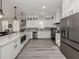 Bright modern kitchen featuring white cabinets, quartz countertops, stainless appliances and luxury vinyl flooring at 501 Tamiami N Trl # 502, Venice, FL 34285