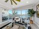 Inviting living room with water views, balcony access, and stylish furnishings at 501 Tamiami N Trl # 502, Venice, FL 34285