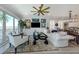 Bright living room featuring a comfortable sofa, modern decor, and large windows at 501 Tamiami N Trl # 502, Venice, FL 34285
