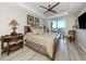 Comfortable main bedroom with a decorative ceiling fan and a private balcony overlooking the water at 501 Tamiami N Trl # 502, Venice, FL 34285