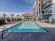 Community pool and sun lounging area, perfect for relaxation at 501 Tamiami N Trl # 502, Venice, FL 34285