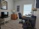Well lit office features a rolling desk chair and a white desk at 530 Walnut Cir, Venice, FL 34285