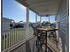 Covered porch with outdoor seating and a view of the community at 530 Walnut Cir, Venice, FL 34285