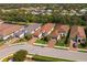 Aerial view of homes with well-maintained landscaping, and paver driveways at 5665 Piccolo St, Nokomis, FL 34275