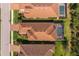 Aerial view of tile rooftops and screened-in pools in a residential neighborhood at 5665 Piccolo St, Nokomis, FL 34275