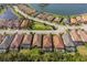 Aerial view of homes with pools surrounding a scenic lake in a residential community at 5665 Piccolo St, Nokomis, FL 34275