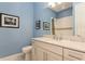 Stylish bathroom featuring granite countertops, and a shower with white subway tile surround and gray accent strip at 5665 Piccolo St, Nokomis, FL 34275