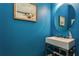 Chic powder room with an elegant vessel sink, modern faucet, and stylish blue wall paint at 5665 Piccolo St, Nokomis, FL 34275