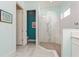 Modern bathroom featuring a glass shower, tile flooring, and soft blue walls at 5665 Piccolo St, Nokomis, FL 34275