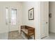 Bright foyer features stylish tile floors, bench seating, and a decorative glass front door at 5665 Piccolo St, Nokomis, FL 34275