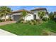 Charming single-story home with lush landscaping, healthy green lawn and a paver driveway at 5665 Piccolo St, Nokomis, FL 34275