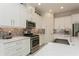 Modern kitchen featuring stainless steel appliances, island with sink and granite countertops at 5665 Piccolo St, Nokomis, FL 34275