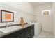 Functional laundry room with washer, dryer, sink, cabinets, and overhead shelving at 5665 Piccolo St, Nokomis, FL 34275