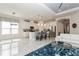 Open concept living room and kitchen featuring a center island with seating and stainless steel appliances at 5665 Piccolo St, Nokomis, FL 34275