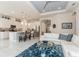 Open concept living and kitchen area with stainless appliances, a center island, and a white leather sofa at 5665 Piccolo St, Nokomis, FL 34275