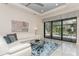 Stylish living room with sliding glass doors leading to a pool and outdoor living space at 5665 Piccolo St, Nokomis, FL 34275