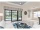 Bright open living area with sliding glass doors to a pool, designer window treatments and stylish decor at 5665 Piccolo St, Nokomis, FL 34275