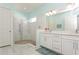 Bathroom featuring a walk-in shower, double vanity, and light-blue walls, providing a clean and spacious feel at 5665 Piccolo St, Nokomis, FL 34275