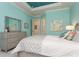 Bright bedroom with an ensuite bathroom, light blue walls and stylish decor and lighting at 5665 Piccolo St, Nokomis, FL 34275