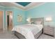 Light and airy bedroom with stylish furniture, including a bed, side tables, and colorful art at 5665 Piccolo St, Nokomis, FL 34275
