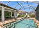 Outdoor pool with comfortable lounge seating surrounded by a screened enclosure at 5665 Piccolo St, Nokomis, FL 34275