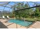 Inviting pool area with clear water, a waterfall feature, and comfortable lounge seating at 5665 Piccolo St, Nokomis, FL 34275