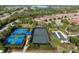 Aerial view of community tennis, pickleball, and bocce ball courts surrounded by landscaping at 5665 Piccolo St, Nokomis, FL 34275