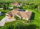 Aerial view of the large home, expansive lawn, and mature landscaping on a sunny day at 5694 Hale Rd, Venice, FL 34293