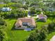 Back of home featuring screen enclosed pool and large manicured backyard on a verdant private lot at 5694 Hale Rd, Venice, FL 34293