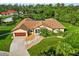 Charming home with beautiful landscaping, decorative stone pathway, and spacious driveway at 5694 Hale Rd, Venice, FL 34293