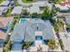 Aerial view of the home featuring a pool, backyard patio, lush landscaping, and driveway at 605 Cornwell On The Gulf, Venice, FL 34285