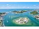 Aerial view of waterfront area with turquoise waters, boats, and beautiful coastal scenery at 605 Cornwell On The Gulf, Venice, FL 34285