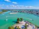Stunning aerial view of waterfront community, turquoise water, and docked boats on a sunny day at 605 Cornwell On The Gulf, Venice, FL 34285