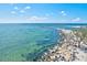 Picturesque aerial view of the waterfront, highlighting the rocky shoreline and tranquil sea at 605 Cornwell On The Gulf, Venice, FL 34285