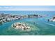 Scenic aerial view of the waterfront area with boats, an island, and buildings in the background at 605 Cornwell On The Gulf, Venice, FL 34285