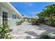 Serene backyard featuring a spacious patio and lush tropical landscaping at 605 Cornwell On The Gulf, Venice, FL 34285