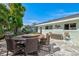 Backyard patio features a large round table with seating, ideal for outdoor dining and entertaining at 605 Cornwell On The Gulf, Venice, FL 34285