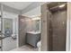 Modern bathroom with tile shower, sleek vanity, and stylish seashell accents at 605 Cornwell On The Gulf, Venice, FL 34285