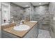 Bathroom featuring double vanity, decorative tile, and walk in shower at 605 Cornwell On The Gulf, Venice, FL 34285