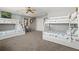 Bright bedroom with multiple bunk beds, ceiling fan, and neutral decor at 605 Cornwell On The Gulf, Venice, FL 34285