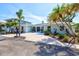 Charming coastal home with lush landscaping and a spacious driveway at 605 Cornwell On The Gulf, Venice, FL 34285