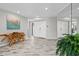 Spacious foyer with stylish wood-look tile flooring, elegant console table, and decorative mirror accent at 605 Cornwell On The Gulf, Venice, FL 34285