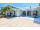 Inviting front entrance with covered porch and elegant architectural details at 605 Cornwell On The Gulf, Venice, FL 34285