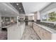 Well-lit kitchen with island seating, stainless steel appliances, and open layout at 605 Cornwell On The Gulf, Venice, FL 34285